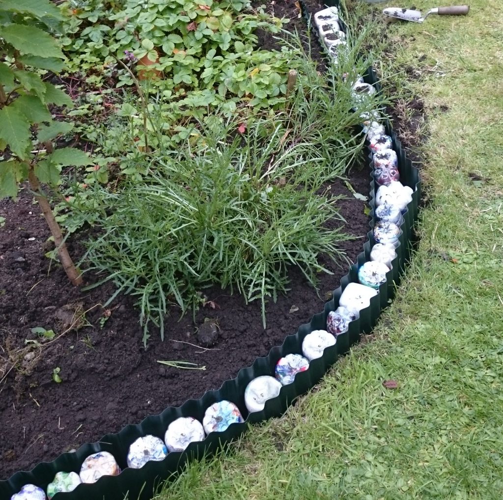 Sustainable Me: Image shows eco bricks made by Ann Marie Shillito by compacting plastic drinks bottles with those plastics that are not yet recycled. These bottles were used in her garden as a retaining wall.